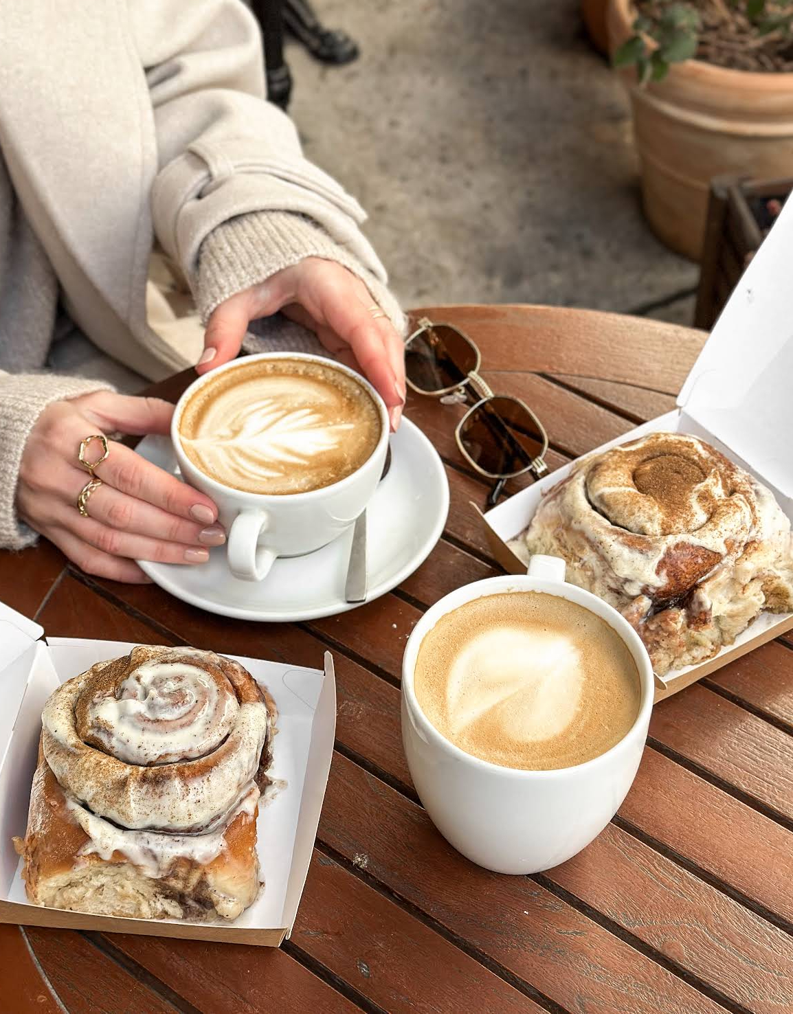 Freshly baked Canela cinnamon rolls with cream cheese glaze